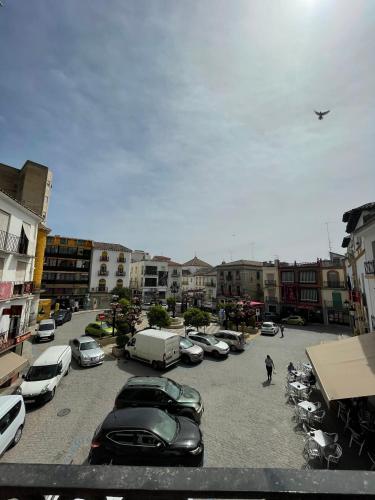a parking lot with a bunch of parked cars at El Mercado in Alcaudete