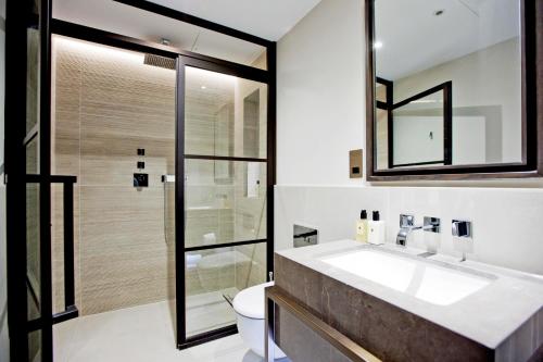 a bathroom with a sink and a toilet at 37GS Residences in London