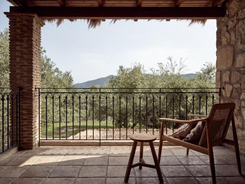 a person sitting in a chair on a balcony with a view at Leeda's Village in Lithakia