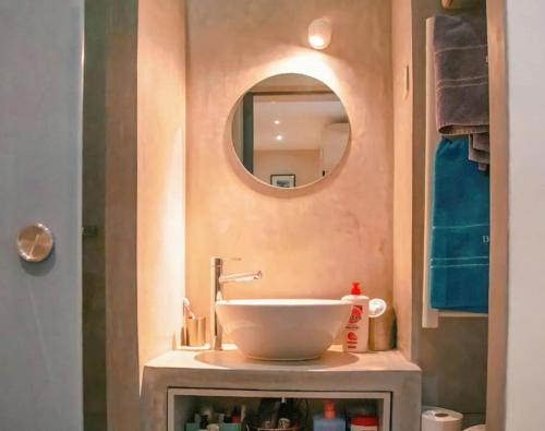 a bathroom with a sink and a mirror at Chez Cam - Paris Rooftop in Paris