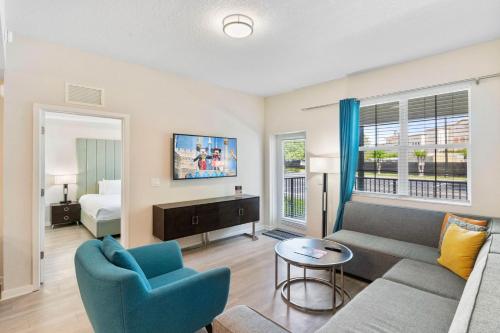 a living room with a couch and a table and a bed at 4013 Breakview Drive 108 in Orlando