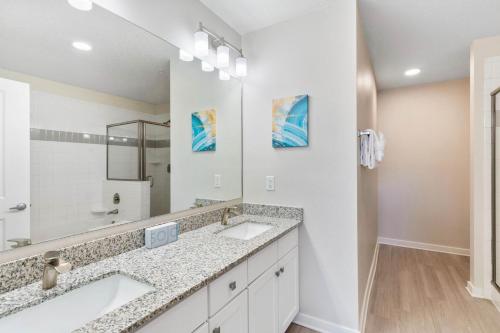 a bathroom with two sinks and a large mirror at 4013 Breakview Drive 108 in Orlando