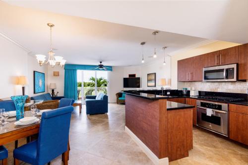 a kitchen and living room with a table and chairs at Divi Village Condo 9 in Palm-Eagle Beach