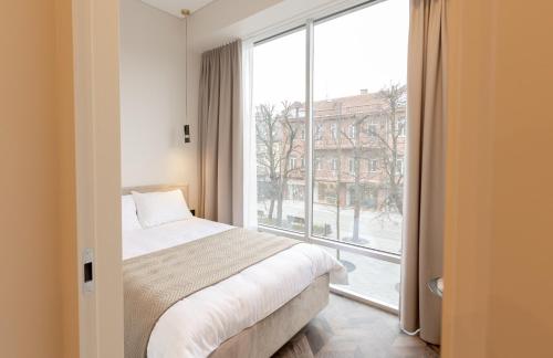 Giường trong phòng chung tại LAISVĖ BOUTIQUE APARTMENTS