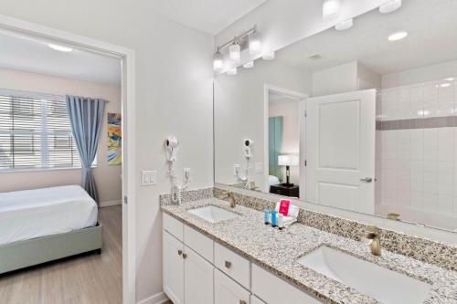 a bathroom with two sinks and a large mirror at 4012 Breakview Drive 210 in Orlando