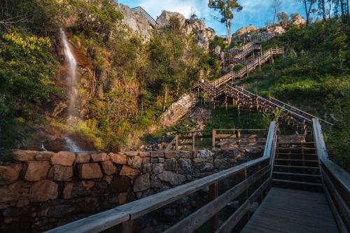 a set of stairs leading up to a waterfall at Casa das Ruas (Xisto Sentido®) in Ameixoeira