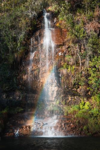 a rainbow at the end of a waterfall at Casa das Ruas (Xisto Sentido®) in Ameixoeira