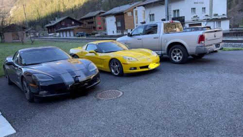 two cars parked in a parking lot next to a truck at Ferienwohnungen Haus Alte Bäckerei in Randa