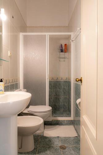 a bathroom with a toilet and a sink and a shower at Casa do Hospital-Guest House in Abaças