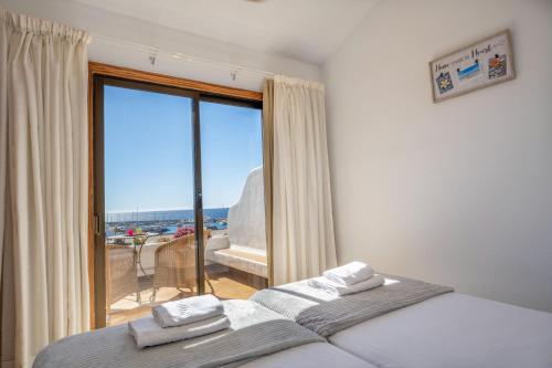 a bedroom with a bed and a large window at Irina Beach Apartment in San Miguel de Abona