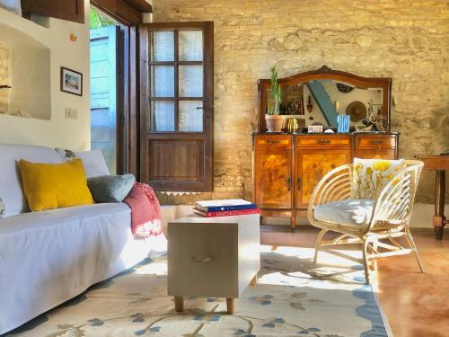 a living room with a couch and a chair at Effimera - Relaxing Retreat in Citta' Sant'Angelo