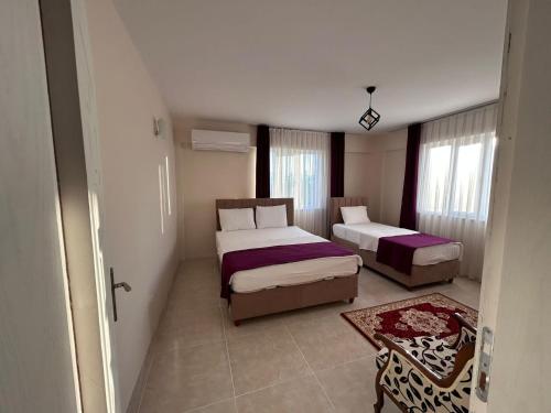 a small bedroom with two beds and a table at The Titanic House Hotel in Pamukkale