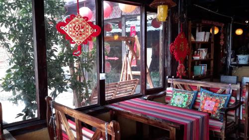 a bench sitting in front of a store window at Timeless Inn in Shangri-La