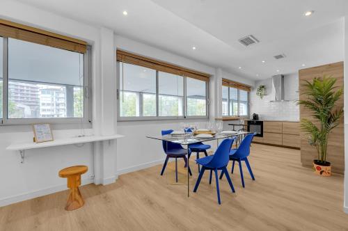 une salle à manger avec une table et des chaises bleues dans l'établissement Le Sant Salvador - Appartement près du canal, à Toulouse