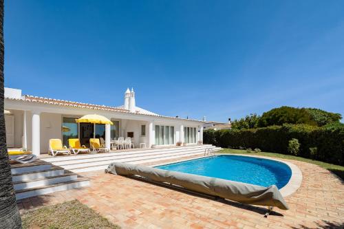 a swimming pool in front of a house at Casa Igreja in Carvoeiro