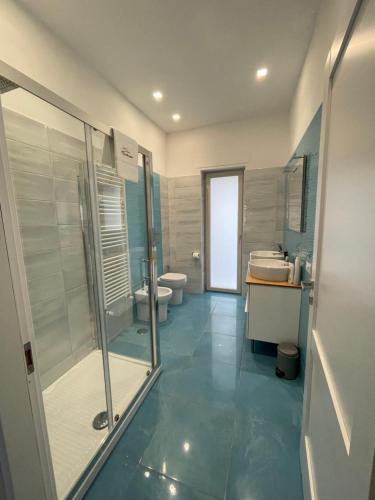 a bathroom with a shower and a toilet and a sink at Casa Langellotti plus in Naples