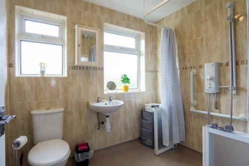 a bathroom with a toilet and a sink at Air Host and Stay - Strawberry Field House in Liverpool