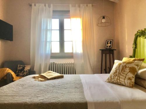 a bedroom with a white bed with a window at Effimera - Relaxing Retreat in Citta' Sant'Angelo