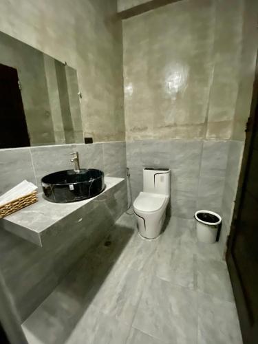 a bathroom with a sink and a toilet at Hai Inn in Dumaguete