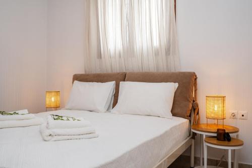 a bedroom with two beds with white sheets and two lamps at Orkos Naxian Wave 3 in Mikri Vigla