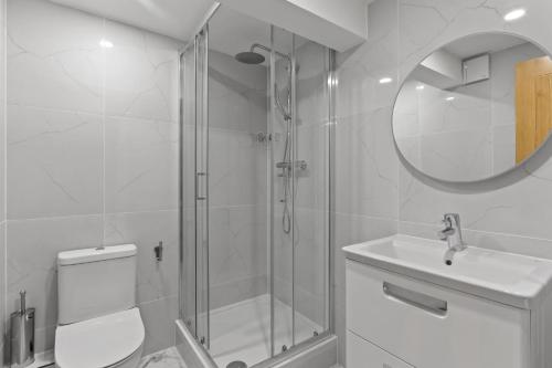 a bathroom with a shower and a toilet and a sink at London's boutique studio in London