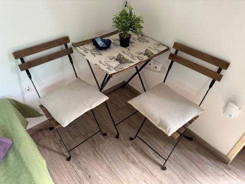 a small table and two chairs in a room at Casa Borgo in Bale