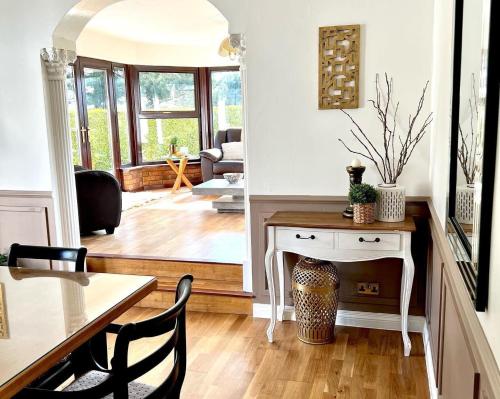 a living room with a table and chairs and a dining room at Fairways Villa Newcastle in Newcastle