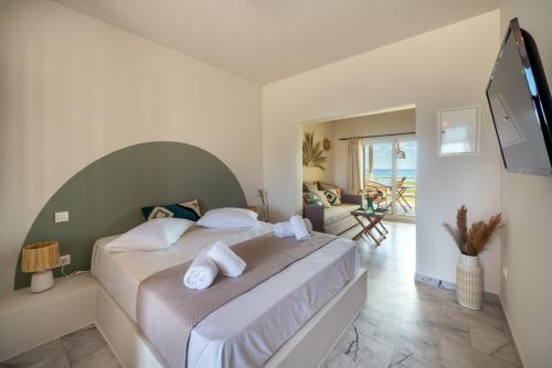 a bedroom with a large bed with towels on it at Grand Bleu Anastazia in Porto Heli