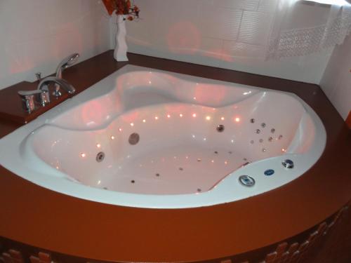 a bath tub with lights in a bathroom at Dom Wakacyjny w Karkonoszach in Kowary