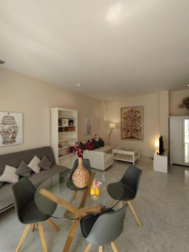 a living room with a couch and a table and chairs at Alleanza, Suite Cathedral, Private Rooftop in Seville