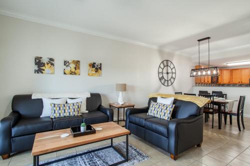 a living room with two couches and a table at Mountain Retreat Condo View Community Amenities in Pigeon Forge