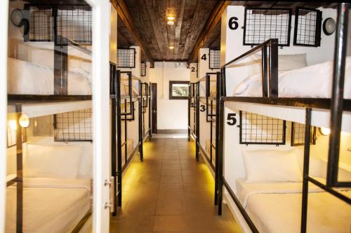 a corridor of bunk beds in a dorm room at Mad Monkey Luang Prabang in Luang Prabang