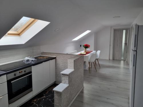 a kitchen with a sink and a counter top at Izabella Guest House in Săcele