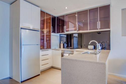 a kitchen with a white refrigerator and a sink at Golden Height in eMalahleni