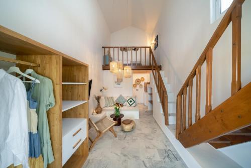 an attic hallway with stairs and a room with a staircase at Grand Bleu Anastazia in Porto Heli