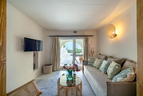 a living room with a couch and a table at Grand Bleu Anastazia in Porto Heli