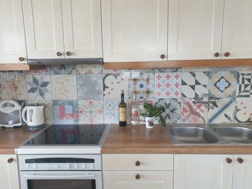 a kitchen with a sink and a stove top oven at Sunset Holiday House in Archangelos