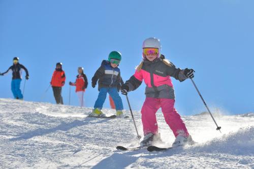 a group of people skiing down a snow covered slope at Chalet Windegg in Sankt Anton am Arlberg