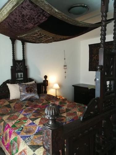 a bedroom with a bed with a quilt on it at Gästehaus Fuchsröhre in Welcherath