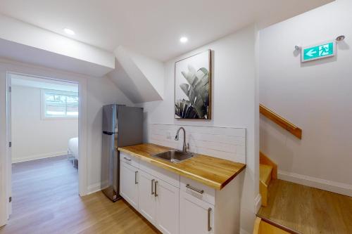 a kitchen with a sink and a refrigerator at The Cottages at Blue in Blue Mountains