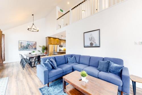 a living room with a blue couch and a table at The Cottages at Blue in Blue Mountains