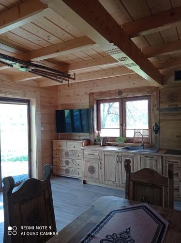 a kitchen in a log cabin with a table at Goramiba in Jurgów
