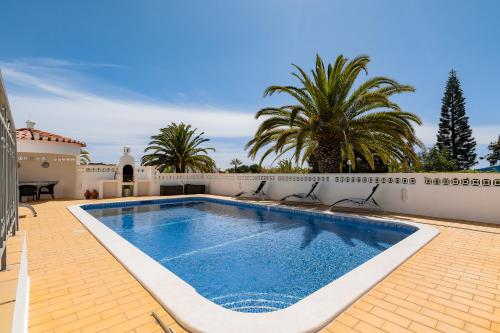 a swimming pool in the backyard of a house at Casa Pitanga in Carvoeiro