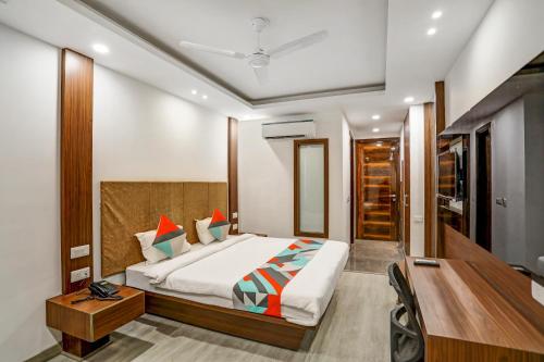 a hotel room with a bed and a desk and a desk at Windsor Castle Premier Cyber City in Gurgaon