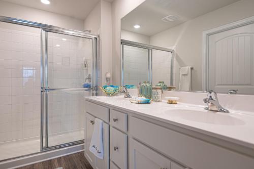 a white bathroom with a sink and a shower at Endless Summer Rental in Millville