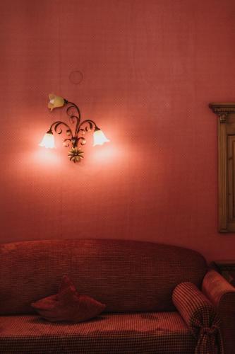 a living room with a couch and two lights on the wall at Hotel Mühlbacherhof in Lagundo