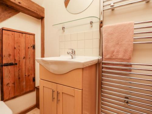 a bathroom with a sink and a shower at Blackbird Cottage in Canterbury