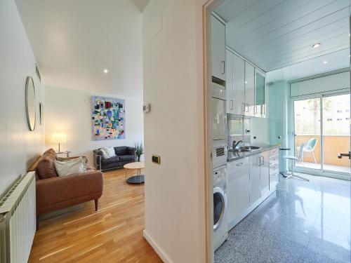 a kitchen and living room with a washer and dryer at Barcelonaforrent Vila Olimpica Pool Suites in Barcelona