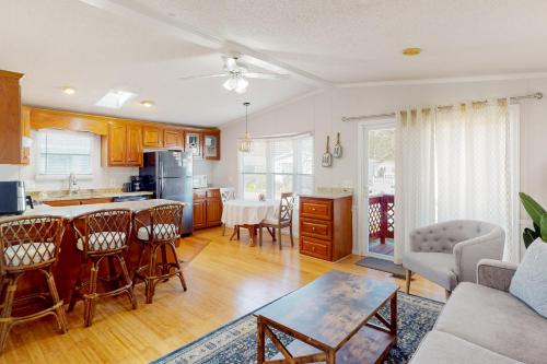 a kitchen and living room with a table and chairs at Assateague Pointe - Yardarm in Berlin