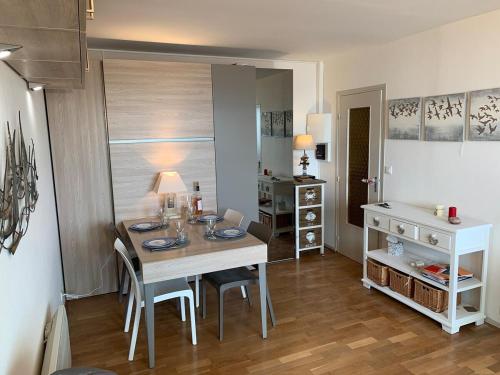 une salle à manger avec une table et des chaises dans une pièce dans l'établissement Grand studio pour 4 face à la mer, à Villers-sur-Mer